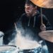 Drummer rehearsing on drums before rock concert. Man recording music on drum set in studio
