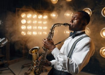 Black jazz performer plays the saxophone on stage