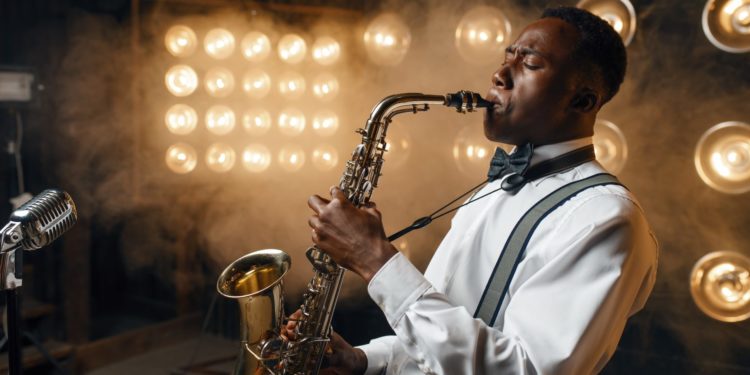 Black jazz performer plays the saxophone on stage