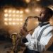 Black jazz performer plays the saxophone on stage