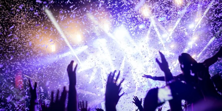 Portrait of happy crowd enjoying at music festival
